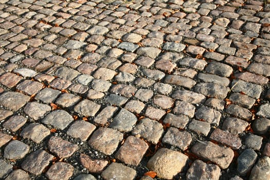 not created abstractions, curves, lines, patterns; cobble stones  street in the sun 