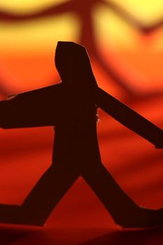 small rudimentary figures of man in paper