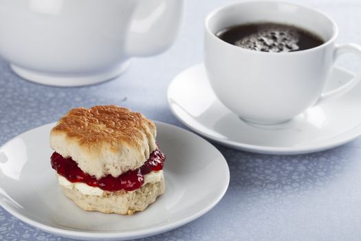 English scones with cream and strawberry jam with tea