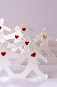 small rudimentary figures of man in paper