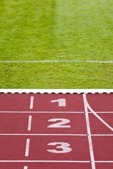 Numbers of track lanes in sports runway, green grass, background for design