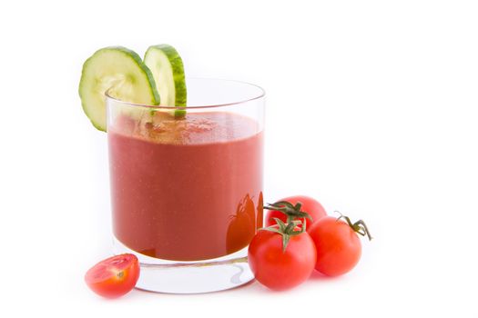 Fresh tomato juice with slices of cucumber isolated on white