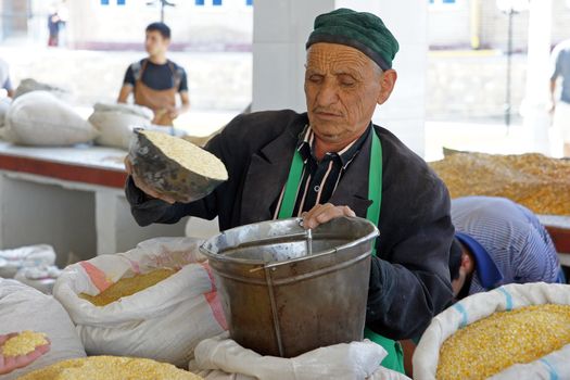 Man trading on a food market. Photo was taken in Samarkand, Uzbekistan.