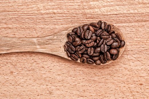 wooden spoon from coffee on a wooden table