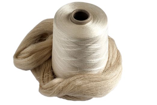 Silk yarn bobbin and raw silk skein isolated on white background