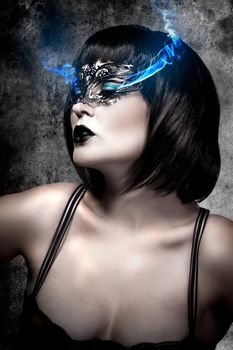 Beautiful woman with short hair and Venetian mask, gas electric blue