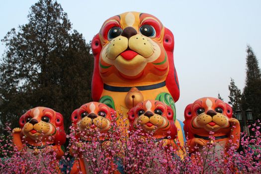 Chinese, Lunar, New Year Decorations, Ditan Park, Beijing, China, Dogs and Flowers.  Another name for Chinese New Year is the spring festival.  Thus, the flowers.