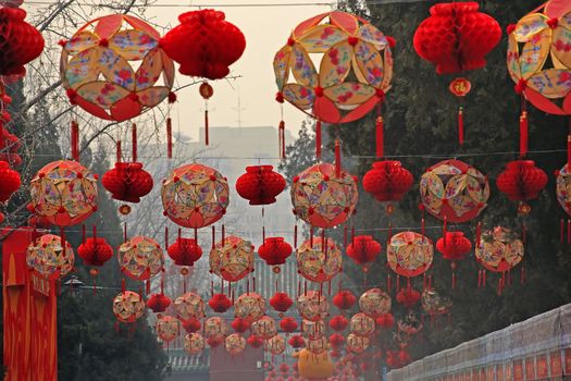 Lucky Red Lanterns Chinese New Year Decorations Ditan Park Beijing China.  During Lunar New Year, many parks and temples in China have large outdoor fairs, festivals.  Chinese characters on lanterns say lucky and long life.