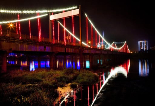 Red Lights Jiangqun Qiao, General Bridge, at Night, Crossing Hun River, Fushun City, Liaoning Province, China Electricity in rural China.