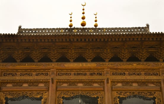 Ornate Wooden Mosque Close Up, Lanzhou City, Gansu Province, China Uighur area.  The characters are not a trademark, but the name of the mosque, Tuan Jie  Bei Si, the United North Mosque, Temple.

