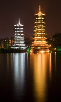 Sun, gold, and Moon, silver, Pagodas, Guilin, Guangxi, China at Night with Reflection