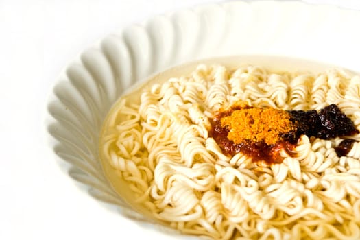 Noodles in a bowl on a white background