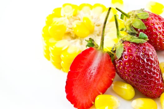 strawberries and corn placed on a white background