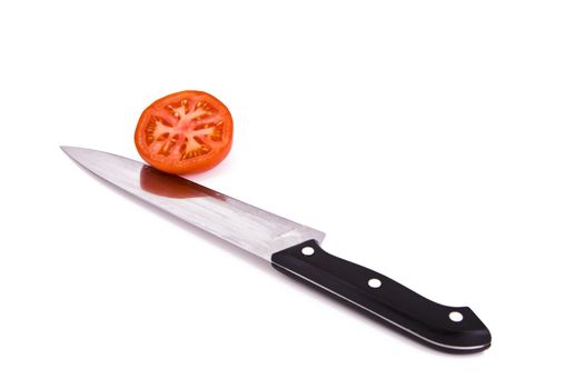 Fresh tomato cut with a kitchen knife isolated on white