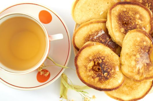 Pancakes  with honey and a cup of tea with linden 