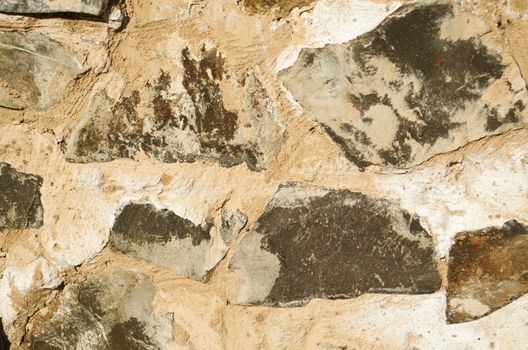 stone wall is made up of rocks and sand