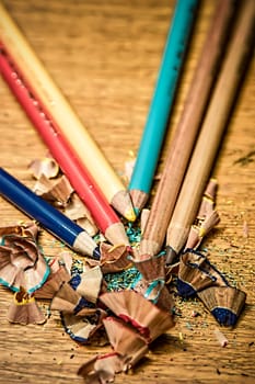 Sharpened color pencils on a wooden desk