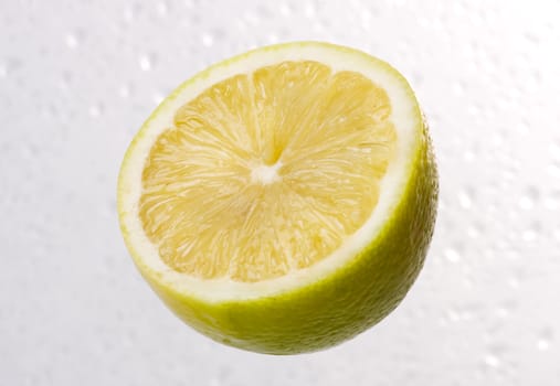 Yellow lemon on dewy background