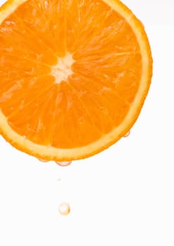 Sliced fresh juicy orange with falling drops