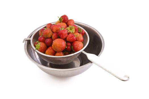 Fresh tasty strawberries in a colander isolated on white