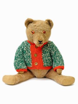 Plush teddy bear dressed in knitted sweater