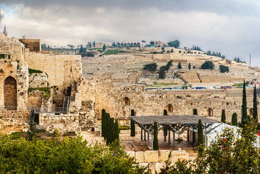 Rebuilt ruins outside the old city wall of Jerusalem, Israel with the Mount of Olives in the background.