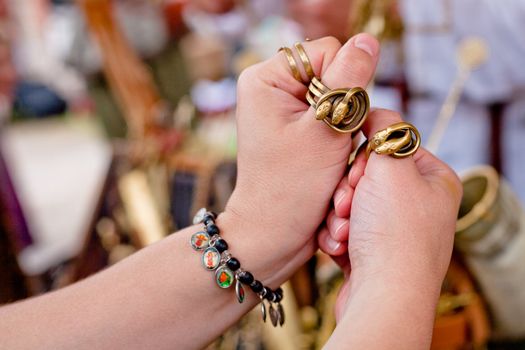 Two yellow rings in form of two snakes on hands
