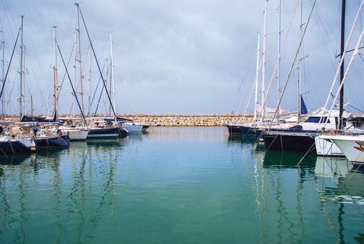 yachts in the harbor standing on an anchor