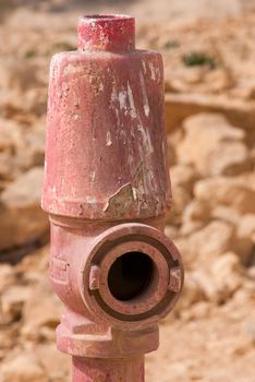 Red fire hydrant on the background of the stones