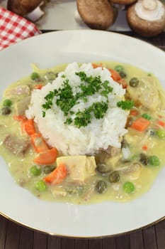 a plate with rice and colorful chicken fricassee