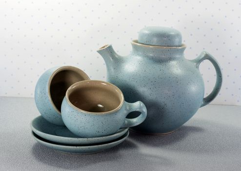 two crockery teacups and teapot 