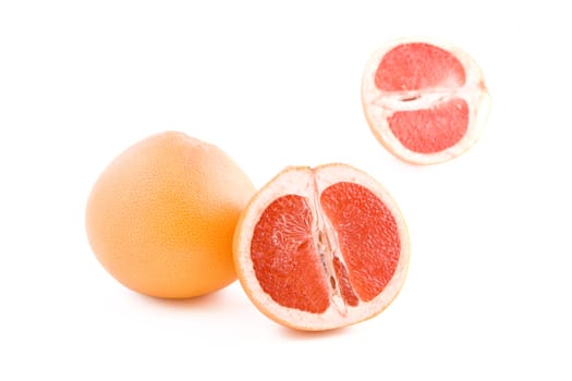 Fresh juicy red grapefruits isolated on white background