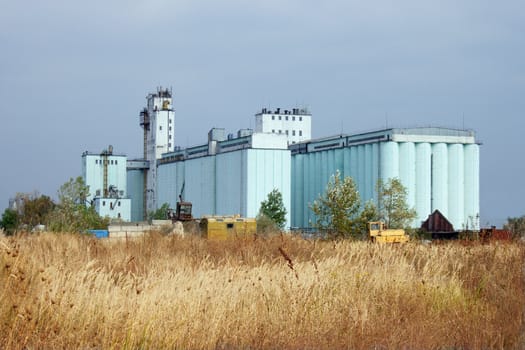 Large grain elevator rises among the steppe