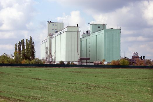 Large grain elevator rises among the fields