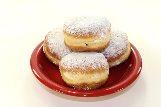 Pancakes with powdered sugar and jam on a plate