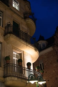 Facade of a beautiful building with balconies and plastic flowers in the evening in Heidelberg, Germany