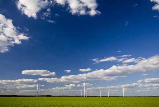 Landscape with windmills with a blue, cloudy sky, alternative energy source