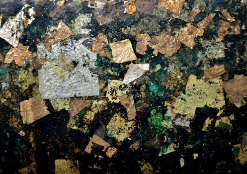 Golden leaf on ancient Buddhist idol in grungy condition