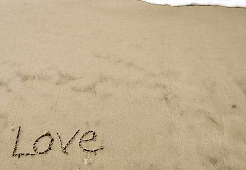 Love written in the sand with wave 9