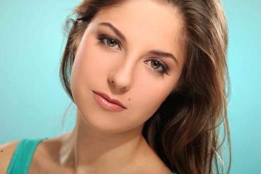 Portrait of young beautiful woman isolated over blue background