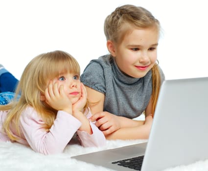 Portrait of a happy young girls with laptop computer. Isolated over white background