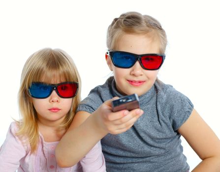 Studio shot of two girls in 3d glasses with control panel watching TV. Isolated white background