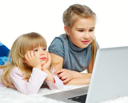 Portrait of a happy young girls with laptop computer. Isolated over white background