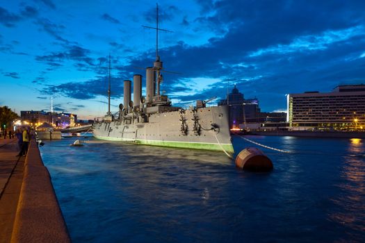 The cruiser Aurora - a symbol of the October Revolution of 1917 in Russia, moored at the Petrograd embankment in St. Petersburg. Shooting in the white nights