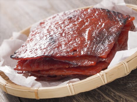 close up of a basket of chinese pork jerky