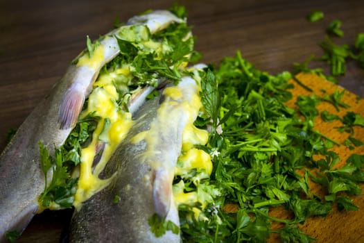 Two raw trouts on the kitchen table, ready to cook