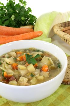 a bowl of cabbage soup and fresh parsley