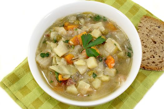 a bowl of cabbage soup and fresh parsley