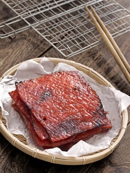 close up of a basket of chinese pork jerky