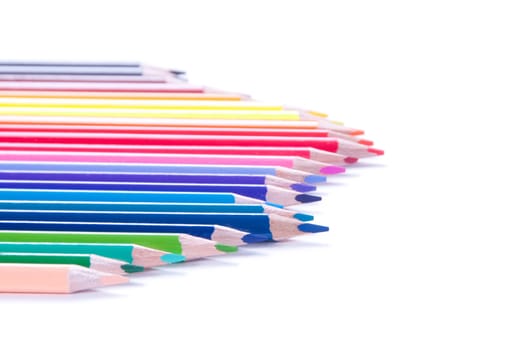 Shot of multicolored pencils in row isolated on white